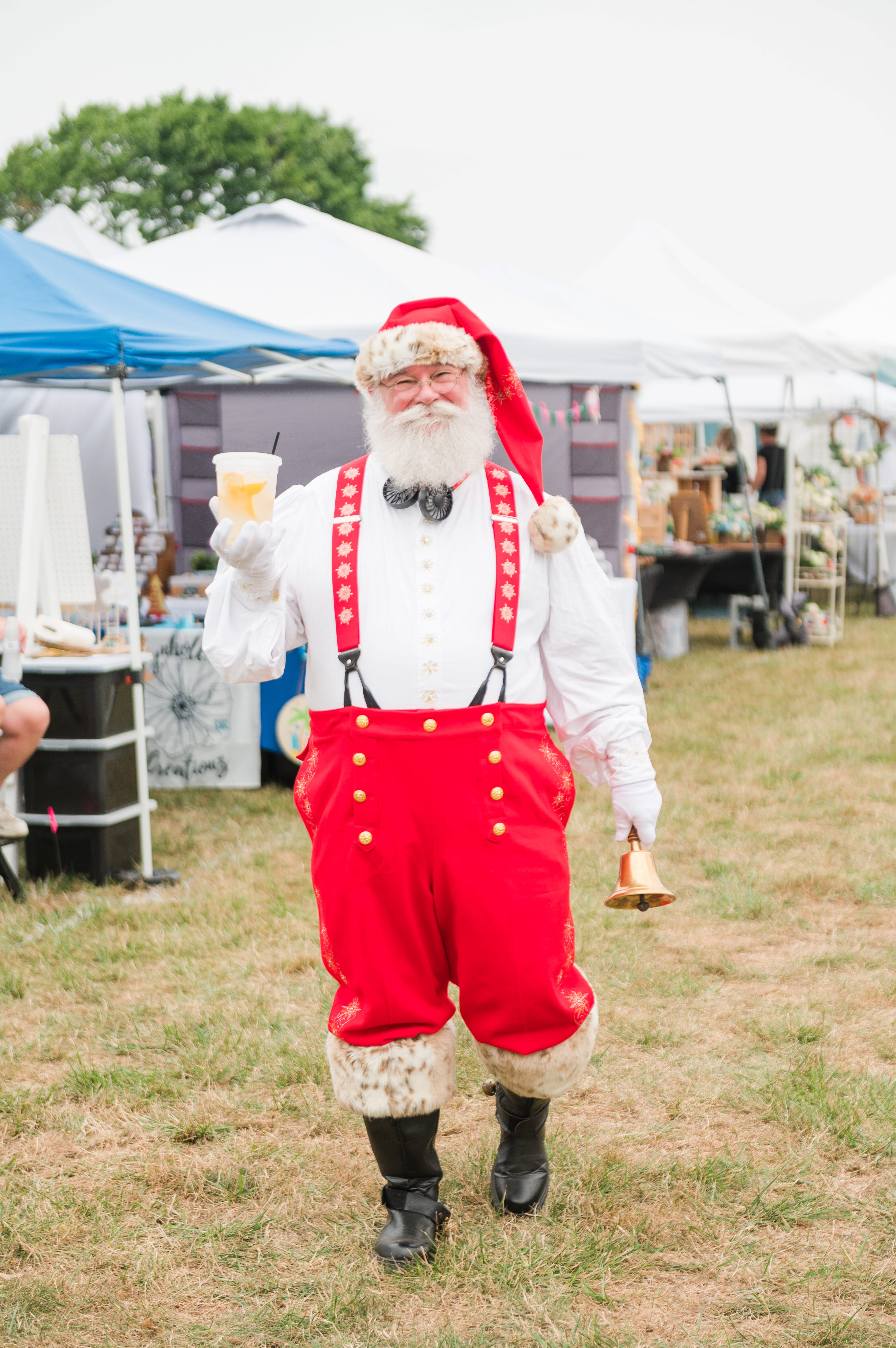 Photo of man dressed up like Santa at an outdoor market