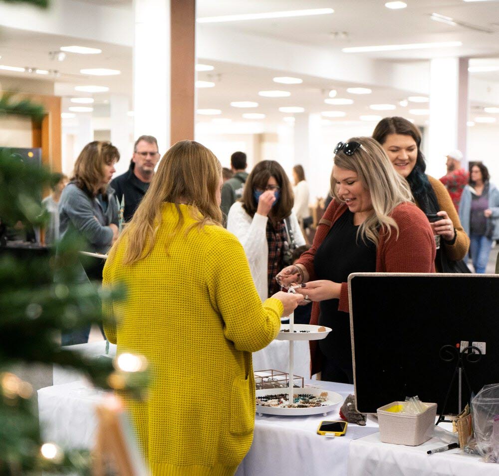 People shopping at an indoor holiday market 